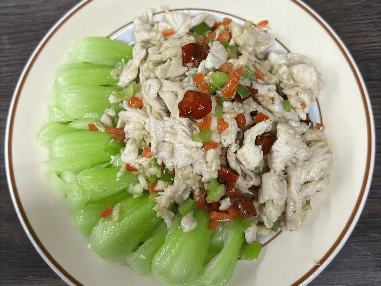Tender chicken served with fresh bok choy and chili at The Top Restaurant And Lounge, a Chinese Restaurant in Clinton