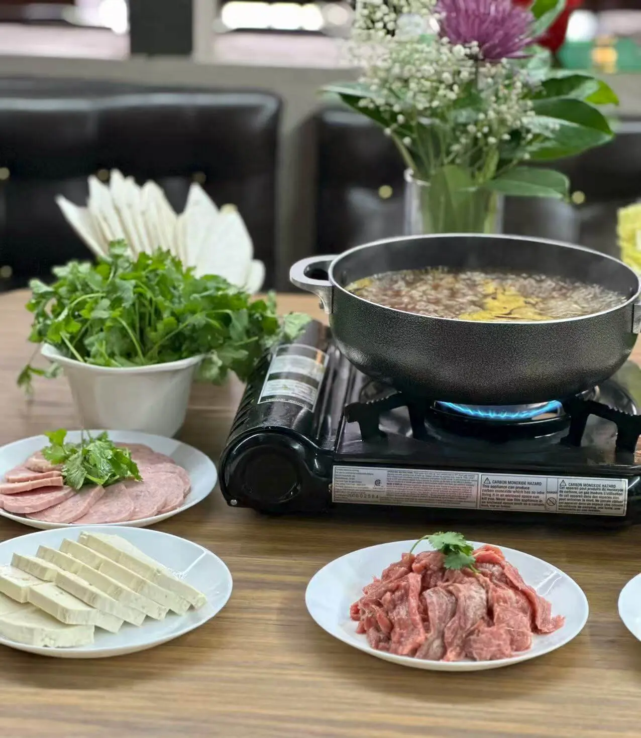 Assorted hot pot ingredients with broth at The Top Restaurant And Lounge, a Chinese Restaurant in Clinton